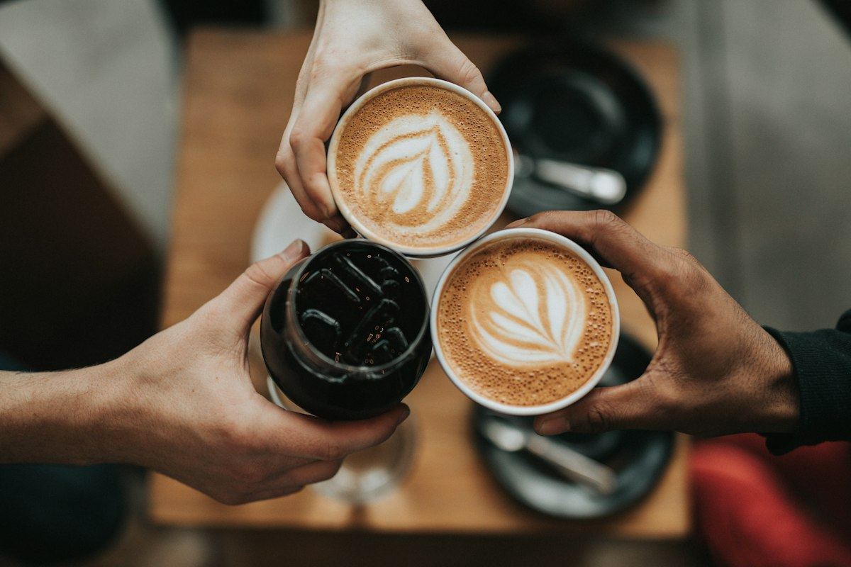 Friends clinking coffee cups