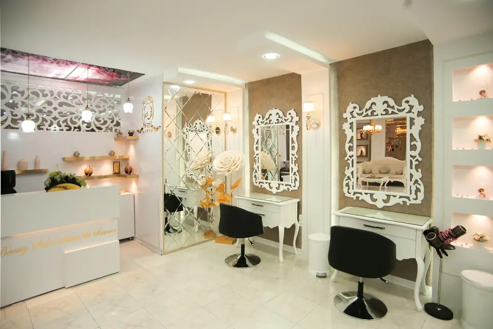 Bright salon interior with styling chairs and ornate white mirrors